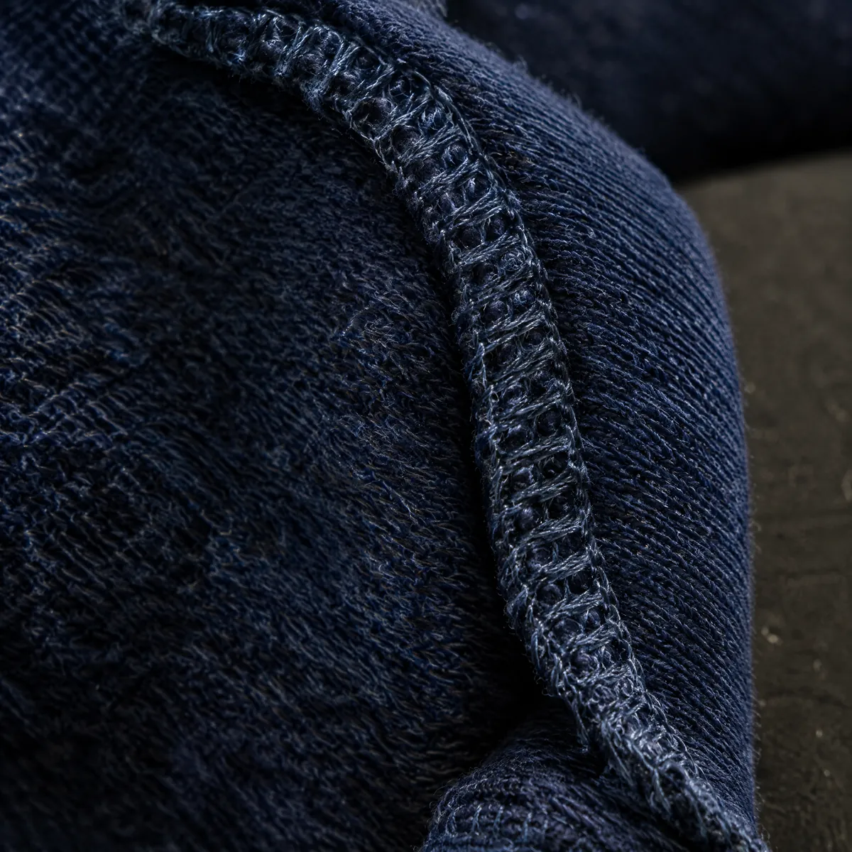 Macro view of an overlocked seam on the inside of a knit garment.